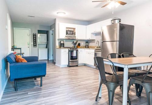 a kitchen and dining room with a table and a refrigerator at Tribesman #18 - Mr Brightside - on Table Rock Lake in Branson