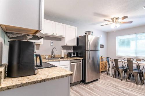 a kitchen with a stainless steel refrigerator and a table at Tribesman #18 - Mr Brightside - on Table Rock Lake in Branson