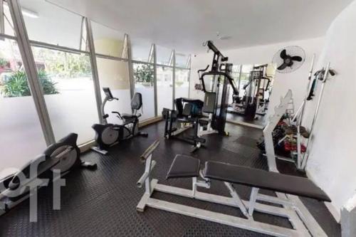 a fitness room with a gym with tread machines at Apê na Barra vista incrível in Rio de Janeiro