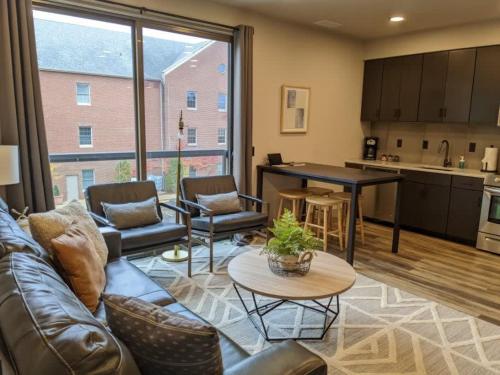 a living room with a couch and a table at Modern Downtown Condo in Traverse City