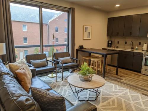 a living room with a couch and a table at Modern Condo 210 Just Blocks from Lake Michigan in Traverse City