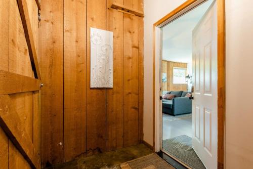 a door leading to a living room with a mirror at Central Bench Garden Guest House in Boise