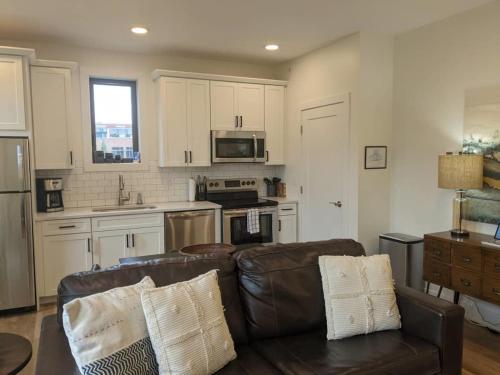 a living room with a couch and a kitchen at Downtown Traverse City Capri Condo 316 in Traverse City