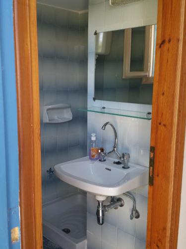 a bathroom with a white sink and a mirror at Guesthouse Karidia in Skala Eresou