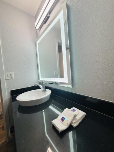 a bathroom with a sink and a mirror at Motel 6-Santa Ana, CA in Santa Ana