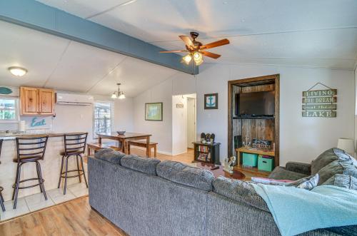 a living room with a couch and a ceiling fan at Monticello Home with Deck and Fire Pit Less Than 1 Mi to Water in Monticello