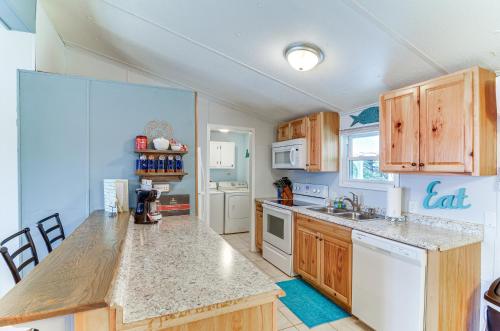 a kitchen with wooden cabinets and a counter top at Monticello Home with Deck and Fire Pit Less Than 1 Mi to Water in Monticello
