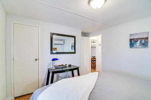a bedroom with a bed and a table with a mirror at Monticello Home with Deck and Fire Pit Less Than 1 Mi to Water in Monticello