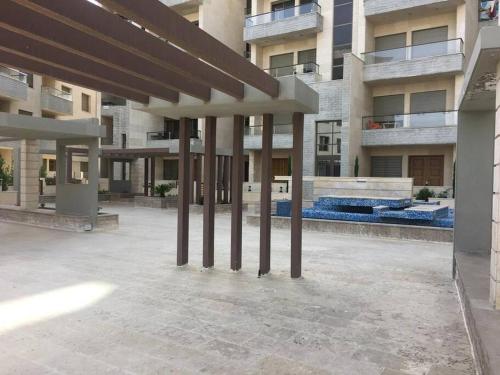 a large building with pillars in the middle of a courtyard at SAK Suites in Rujm ash Sharāʼirah