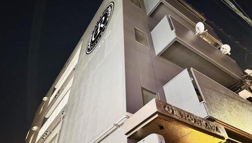 a building with a clock on the side of it at GR HONKAWA - Global Resort Hotel in Hiroshima