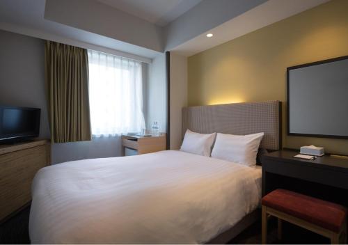 Postel nebo postele na pokoji v ubytování E Hotel Higashi Shinjuku