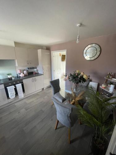 a living room with a table and chairs and a kitchen at 2 bedroom house in Seacroft