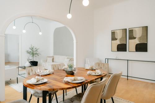 a dining room with a wooden table and chairs at Stylish APT for 4-6 metro & walk 5 min to center in Vienna