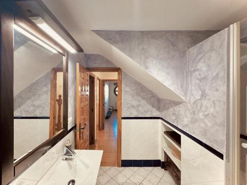 a bathroom with a sink and a staircase at Casa Natura Carabassi Beach in Gran Alacant