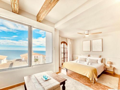 a bedroom with a bed and a large window at Casa Natura Carabassi Beach in Gran Alacant