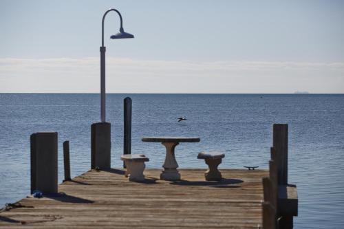 a picnic table on a dock with the water at Seascape Resort & Marina in Marathon