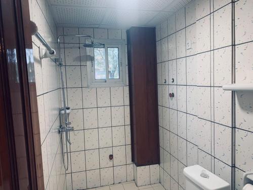 a bathroom with a shower and a toilet at Appartement meublé , Bonamoussadi, Douala-Vanguard's signature Suite in Douala
