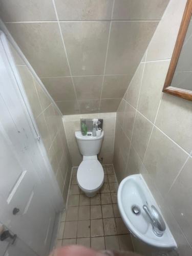 a small bathroom with a toilet and a sink at 11 Chalvey Road east sl12ll in Slough