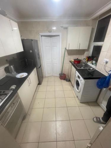 a small kitchen with a washing machine in it at 11 Chalvey Road east sl12ll in Slough