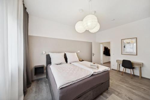 a bedroom with a large bed and a chandelier at Ruhige Lage, gute Anbindung, frisch renoviert in Fellbach