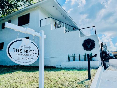 a white house with a sign in front of it at The Moose #6 - Modern Luxe Studio with Free Parking & King Bed in Memphis