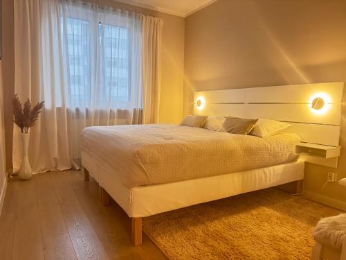 a bedroom with a large bed and a large window at Amelie in Zagreb