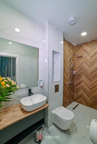 a white bathroom with a sink and a toilet at Хотел Терра Роза in Karlovo