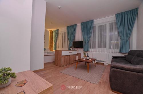 a living room with a couch and a table at Хотел Терра Роза in Karlovo