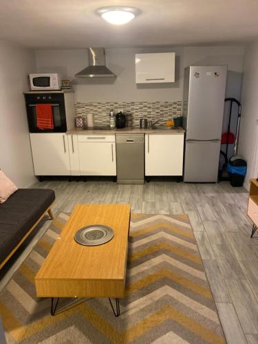 un salon avec une table et une cuisine dans l'établissement Appartement F2 proche Futuroscope, à Buxerolles