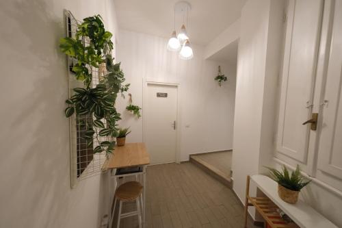 a hallway with plants on the wall and a table at Roman Forum Holiday Termini in Rome