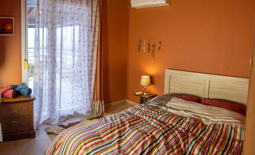a bedroom with a large bed and a window at Xristina's sofita in Kozani
