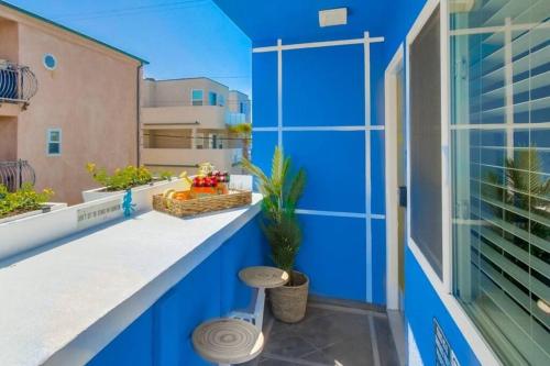 a blue walled balcony with a plant on it at Ocean View Blue Mission Beach Paradise in San Diego