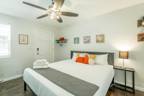 a bedroom with a white bed with a ceiling fan at 12 The Gray Room - A PMI Scenic City Vacation Rental in Chattanooga