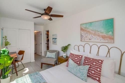 a living room with a bed and a ceiling fan at Ocean View Blue Mission Beach Paradise in San Diego