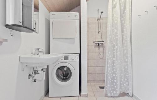 a bathroom with a washing machine and a sink at Holiday Home Bæverstien Dnmk Iv in Marielyst