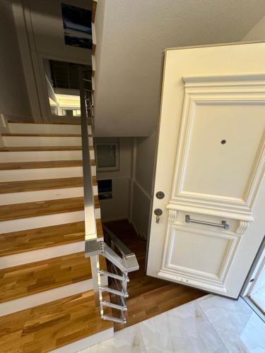 a door leading up to a staircase with a stair case at Royal Villa in Forest in Dosemealti