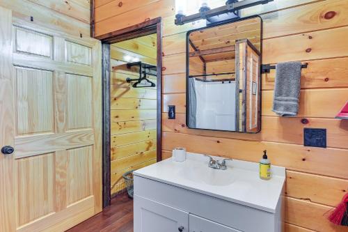 a bathroom with a sink and a mirror at Cabin with Expansive Deck about 4 Mi to Red River Gorge! in Rogers
