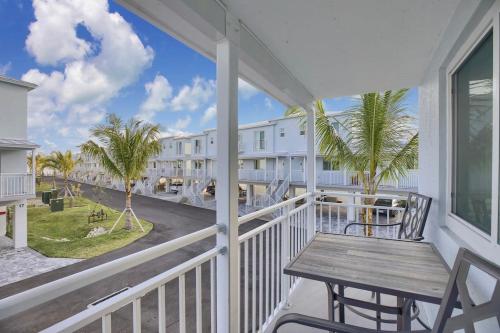 a balcony with a table and a view of the ocean at Carney's Reef NEW 1B 1B Pool Patio in Marathon