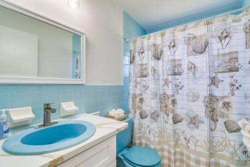 a bathroom with a sink and a shower curtain at Home with Screened Porch, Near Weeki Wachee Springs! in Spring Hill