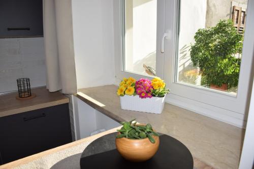 a kitchen with a table with a vase of flowers at Casa Fornace in Ala