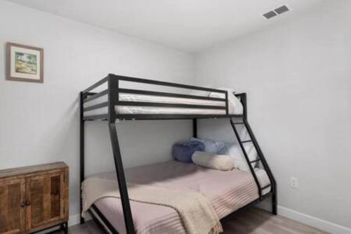 a black bunk bed in a white room at Catchy Relax Bradenton Beauty mins to Beaches in Bradenton