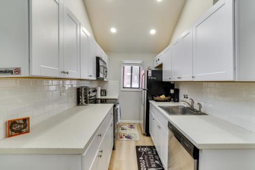 a white kitchen with white cabinets and a sink at Walk to Lake Tobyhanna Home with Hot Tub and Fire Pit in Tobyhanna