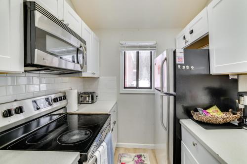 a kitchen with a stove and a refrigerator at Walk to Lake Tobyhanna Home with Hot Tub and Fire Pit in Tobyhanna