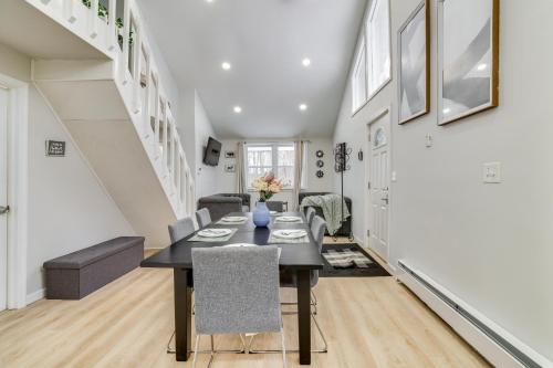 a dining room and living room with a table and chairs at Walk to Lake Tobyhanna Home with Hot Tub and Fire Pit in Tobyhanna