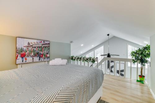 a bedroom with a large bed with a painting on the wall at Walk to Lake Tobyhanna Home with Hot Tub and Fire Pit in Tobyhanna