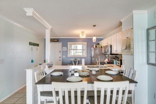 a kitchen with a table and chairs in a room at Steps to the Beach Oceanfront Condo with Lanai! in North Topsail Beach