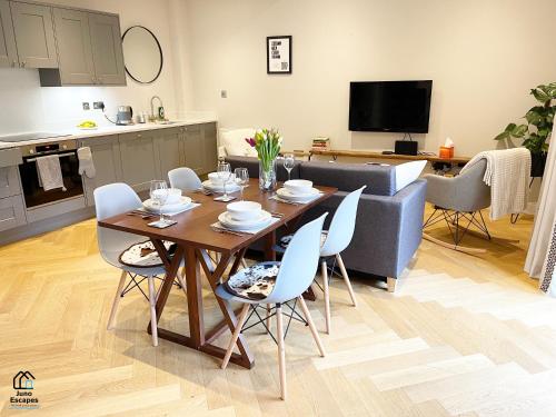 a kitchen and living room with a table and chairs at Character filled Courtyard Escape in Harrogate