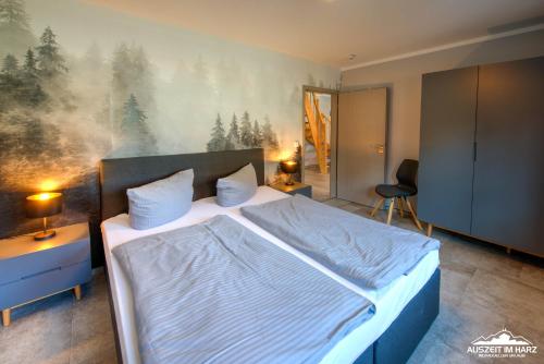 a bedroom with a bed and a painting on the wall at Auszeit-im-Harz Haus 6 Ferienhaus in Wernigerode