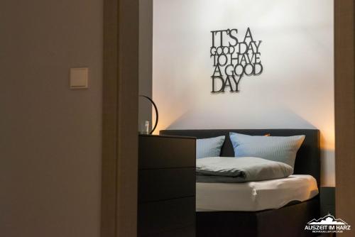 a bedroom with a bed and a dresser at Auszeit-im-Harz Haus 6 Ferienhaus in Wernigerode