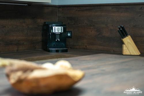 a clock sitting on top of a table next to a knife at Auszeit-im-Harz Haus 6 Ferienhaus in Wernigerode